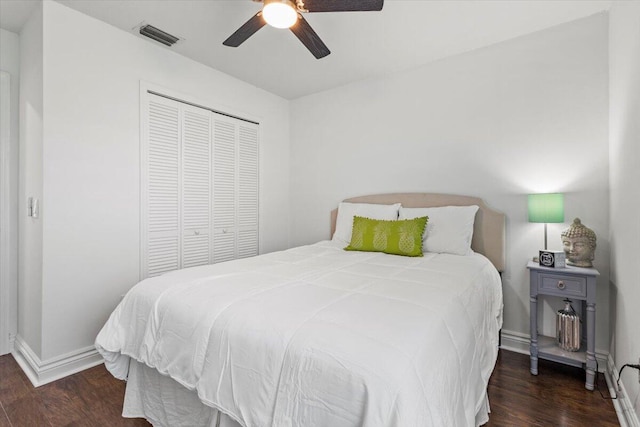 bedroom with dark wood-type flooring, a closet, and ceiling fan