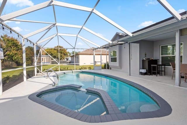 view of swimming pool featuring an in ground hot tub, a lanai, and a patio area