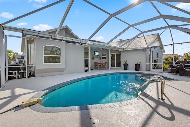 view of pool with a patio, ceiling fan, and glass enclosure