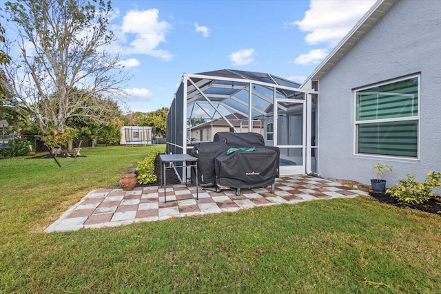 view of yard with a patio and glass enclosure