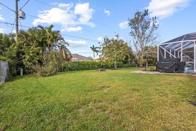 view of yard featuring glass enclosure