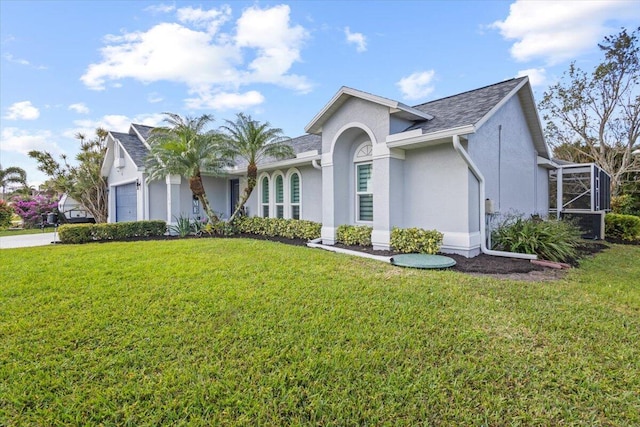 ranch-style home with a garage and a front yard