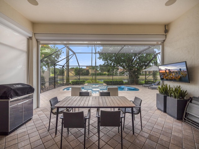 view of patio / terrace featuring a pool with hot tub, glass enclosure, and grilling area