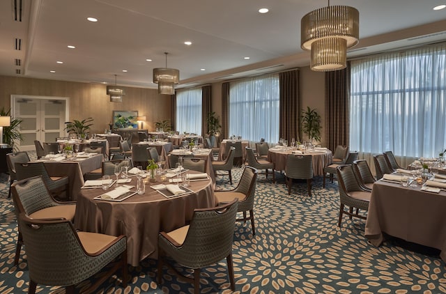 carpeted dining room featuring french doors