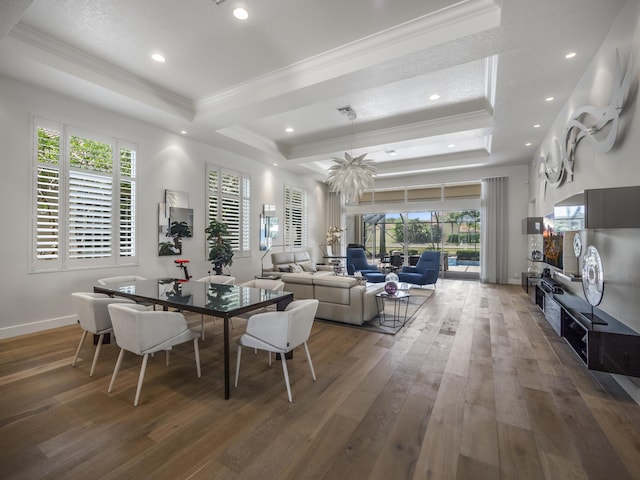 dining room featuring dark wood-type flooring, a tray ceiling, and crown molding