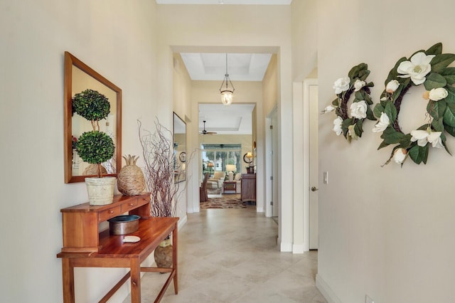 hall with a tray ceiling