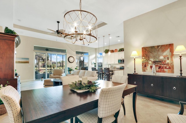 dining space with ceiling fan with notable chandelier