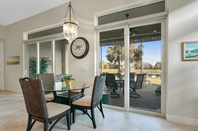 dining space featuring light tile patterned floors and a chandelier