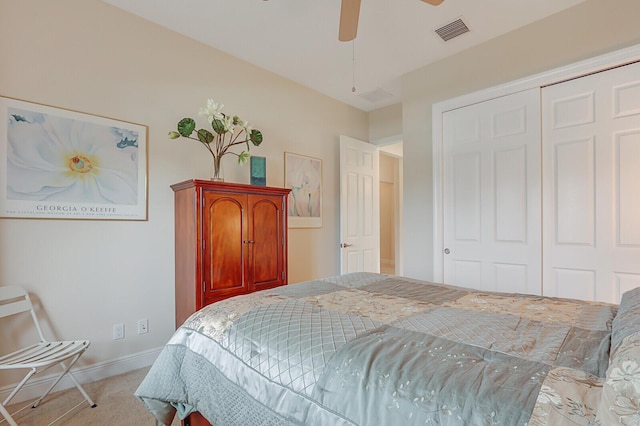 carpeted bedroom featuring ceiling fan and a closet