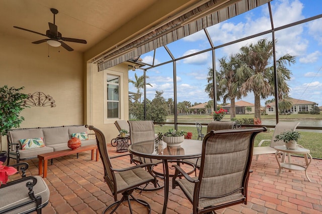 sunroom featuring ceiling fan