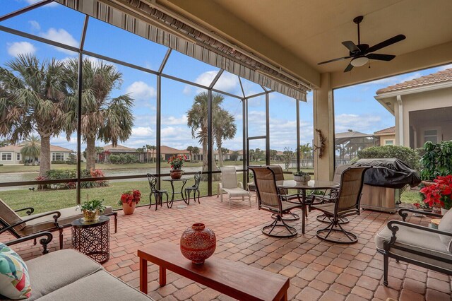 sunroom featuring ceiling fan