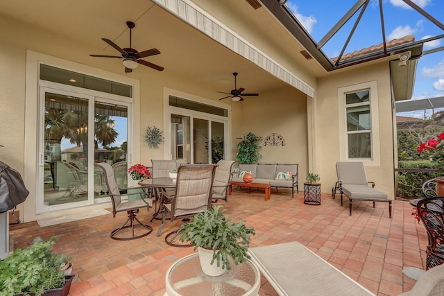 view of patio featuring a lanai, an outdoor hangout area, and ceiling fan