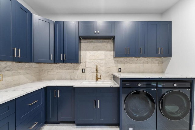 laundry area featuring cabinets, sink, and independent washer and dryer