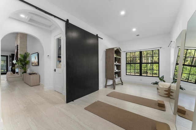 interior space with light hardwood / wood-style flooring and a barn door