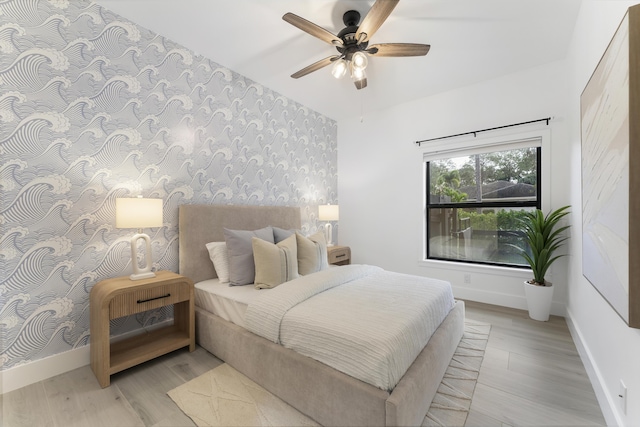 bedroom with ceiling fan and light hardwood / wood-style floors