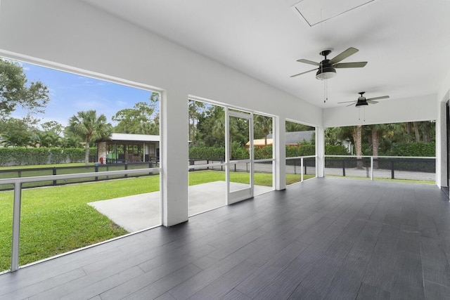 unfurnished sunroom with a healthy amount of sunlight and ceiling fan