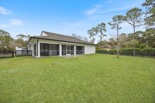 back of house with a yard and a sunroom