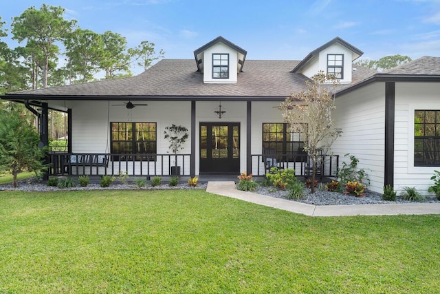 view of front of home with covered porch, a front yard, ceiling fan, and french doors