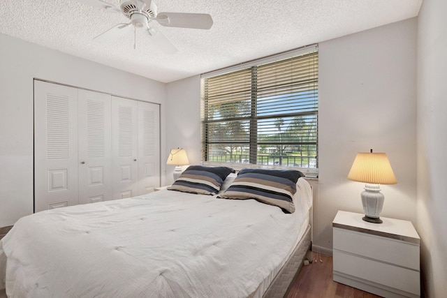 27 Abbey Ln Unit 205, Delray Beach, FL 33446 - bedroom with ceiling fan, dark wood-type flooring, a textured ceiling, and a closet