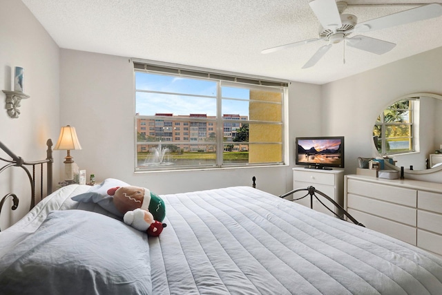 27 Abbey Ln Unit 205, Delray Beach, FL 33446 - bedroom featuring ceiling fan and a textured ceiling