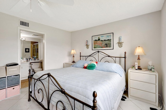 27 Abbey Ln Unit 205, Delray Beach, FL 33446 - bedroom with connected bathroom, a textured ceiling, and light tile patterned floors