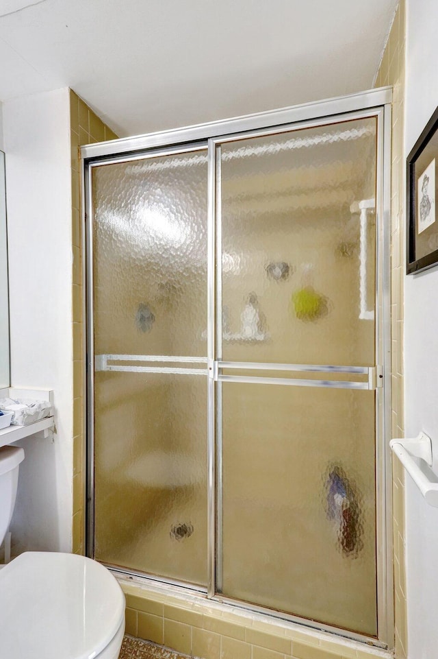 27 Abbey Ln Unit 205, Delray Beach, FL 33446 - bathroom featuring toilet and a shower with shower door