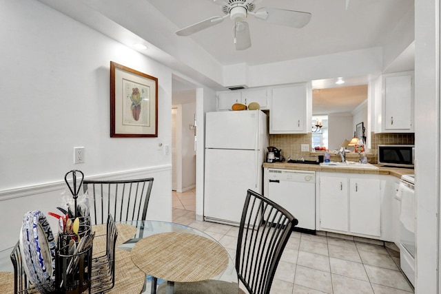 27 Abbey Ln Unit 205, Delray Beach, FL 33446 - kitchen with white cabinetry, light tile patterned flooring, white appliances, and decorative backsplash