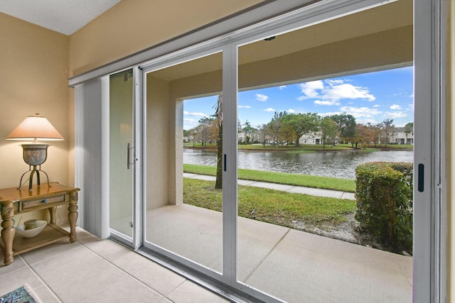 entryway with a water view and tile patterned floors