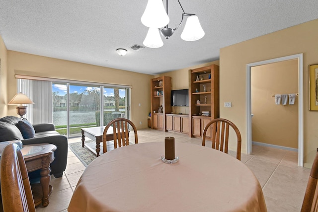 tiled dining area featuring a textured ceiling