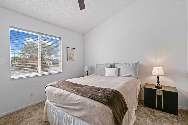 carpeted bedroom featuring ceiling fan, a textured ceiling, and lofted ceiling