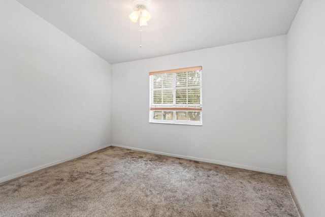 empty room featuring a textured ceiling and carpet flooring