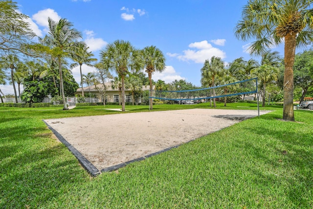 view of community with volleyball court and a lawn