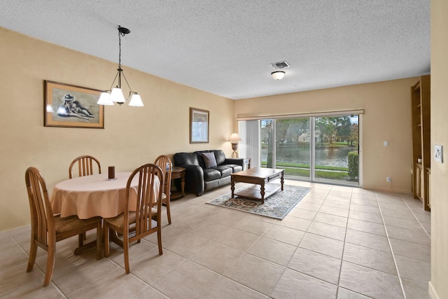 tiled dining area featuring a textured ceiling