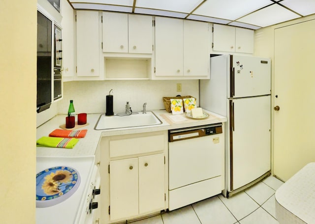 kitchen featuring white cabinetry, sink, white appliances, and light tile patterned floors