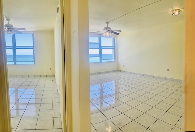 tiled empty room with ceiling fan