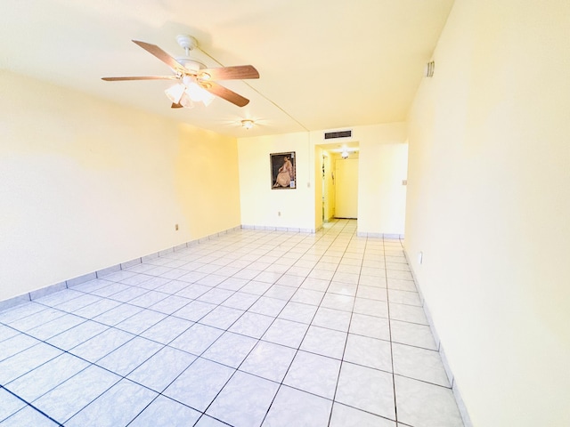 tiled empty room featuring ceiling fan