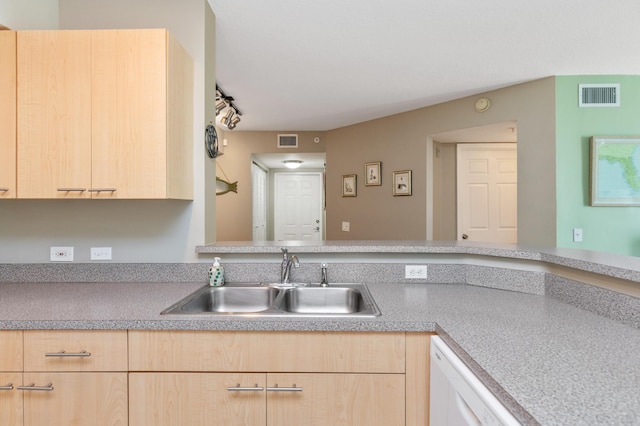 kitchen featuring light brown cabinetry, sink, and dishwasher