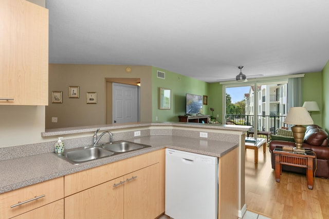 kitchen featuring sink, white dishwasher, kitchen peninsula, light brown cabinets, and light wood-type flooring