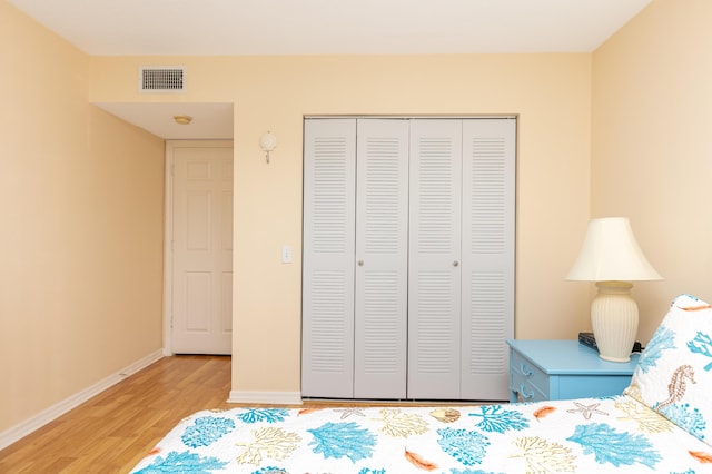 bedroom featuring wood-type flooring and a closet