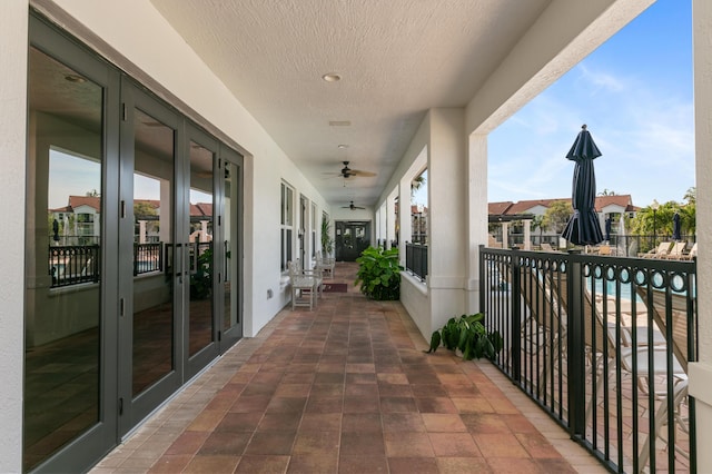 balcony with french doors and ceiling fan