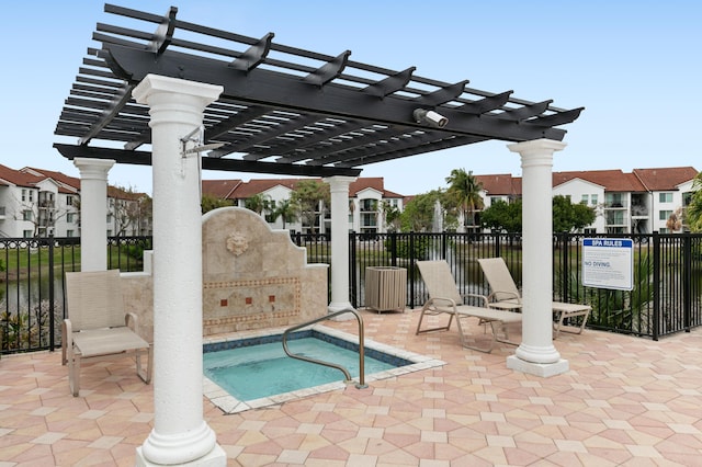 view of patio featuring a community hot tub and a pergola