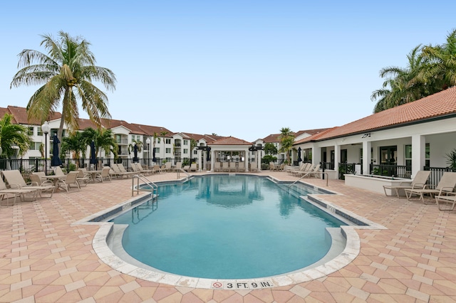 view of swimming pool with a patio