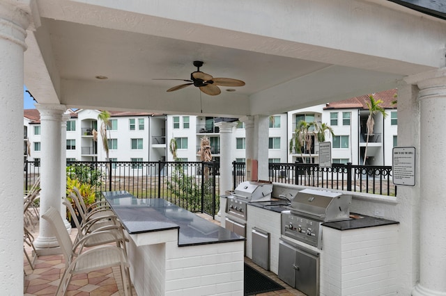 view of patio featuring area for grilling, ceiling fan, and an outdoor wet bar