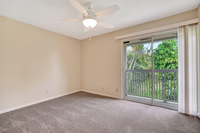 carpeted empty room featuring ceiling fan and a textured ceiling