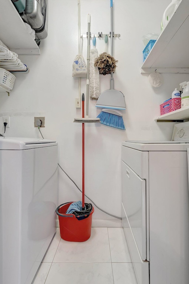 bathroom featuring washing machine and dryer and tile patterned flooring