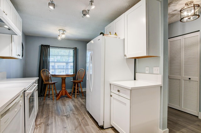 kitchen featuring white cabinetry, white appliances, a textured ceiling, rail lighting, and light hardwood / wood-style floors