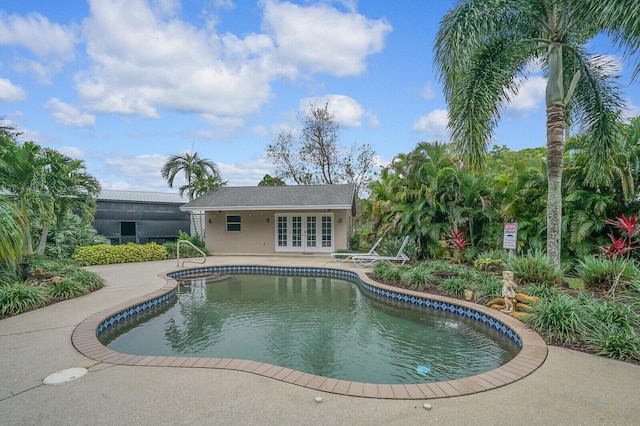 view of pool featuring a patio area and french doors