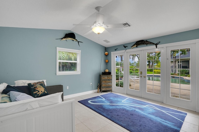 tiled living room featuring vaulted ceiling, ceiling fan, and french doors