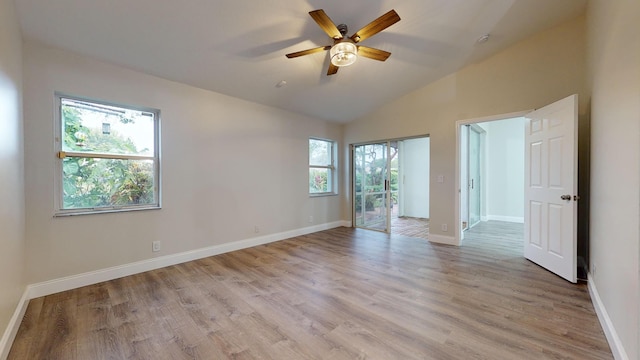 spare room with ceiling fan, light hardwood / wood-style flooring, and vaulted ceiling