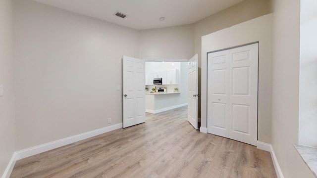 interior space featuring light hardwood / wood-style floors and a closet